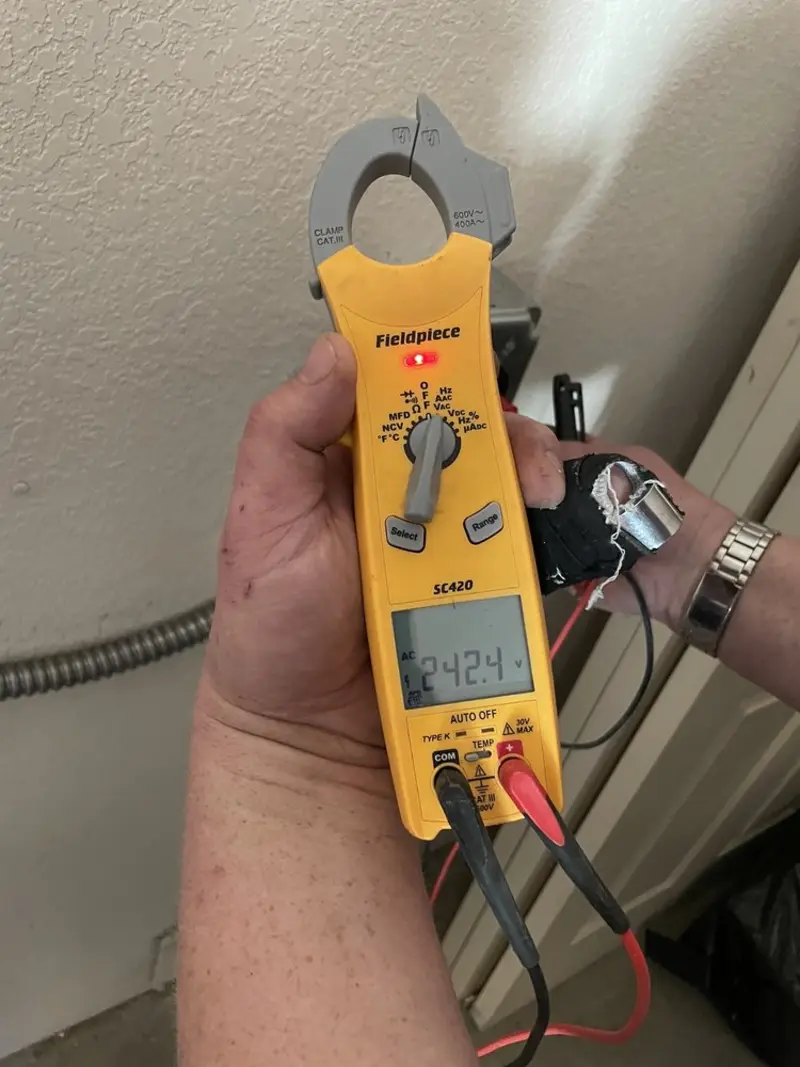 Voltage testing with clamp meter during Ceiling Fan Installation in Royse City